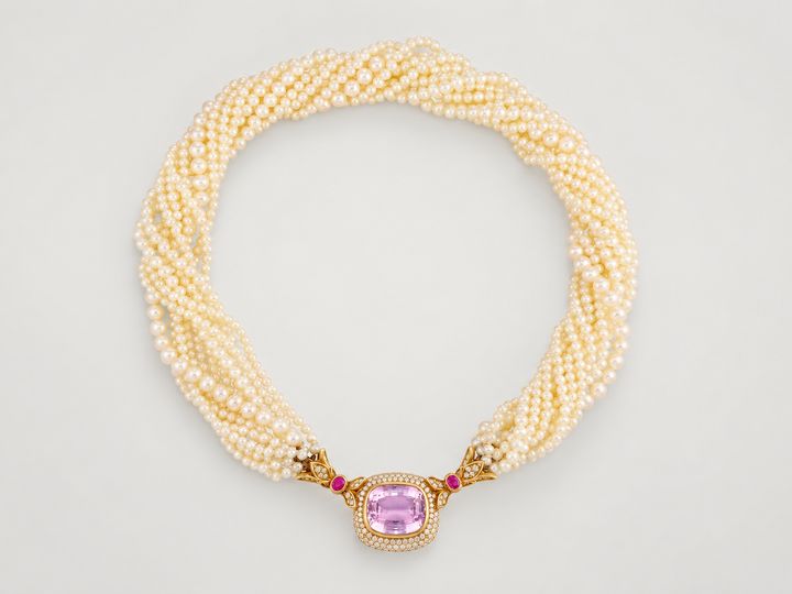 A multi-strand pearl necklace with a pink gemstone, diamond and ruby clasp set in gold