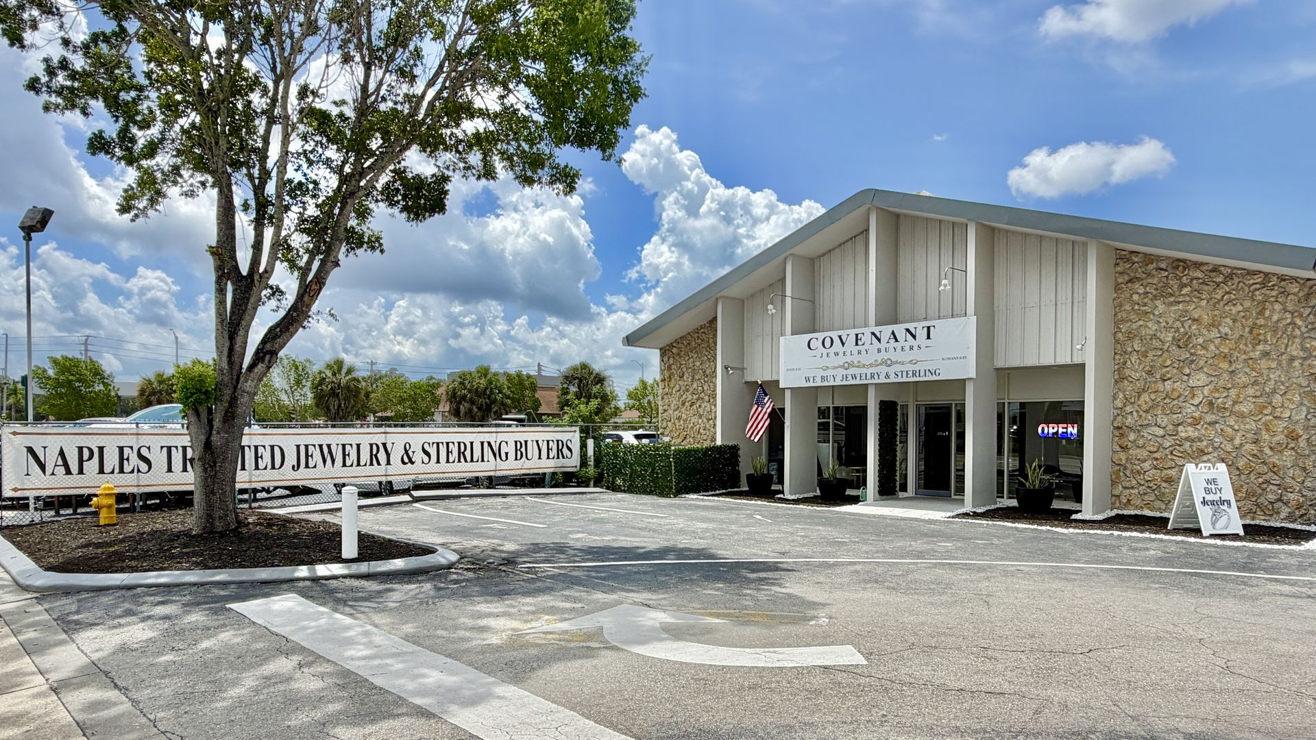 The Covenant Jewelry Buyers building on Davis Blvd in Naples, an A-frame with stone walls and palm trees